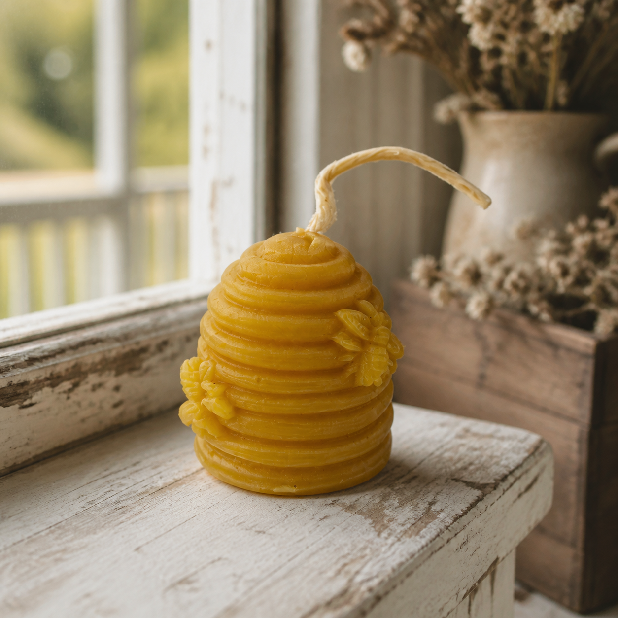 Natural beeswax beehive candle in a rustic farmhouse window setting